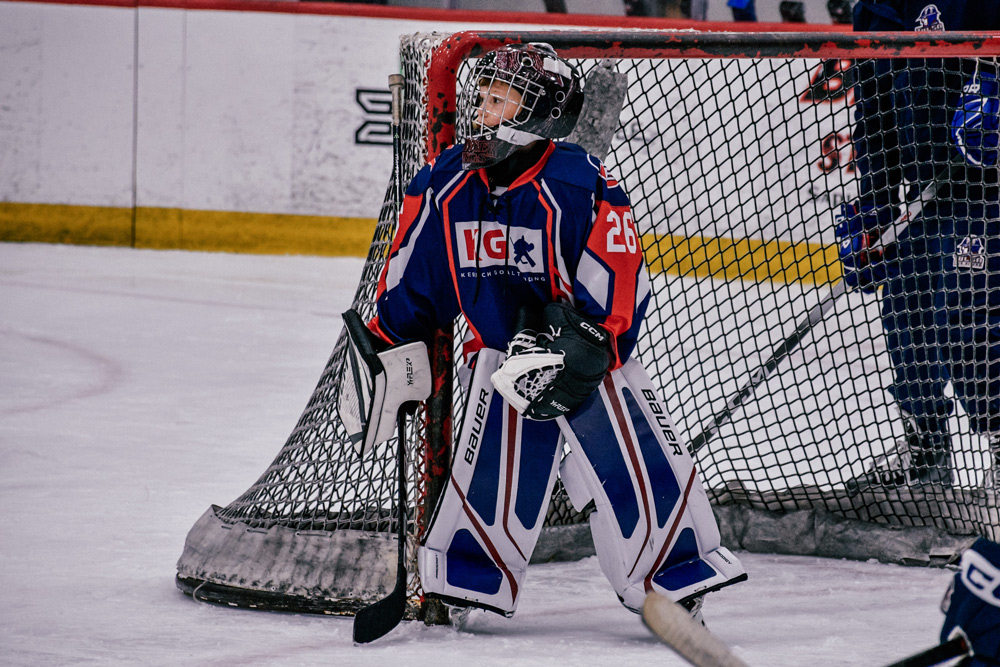 Coaches running a shooting drill with camp goalies