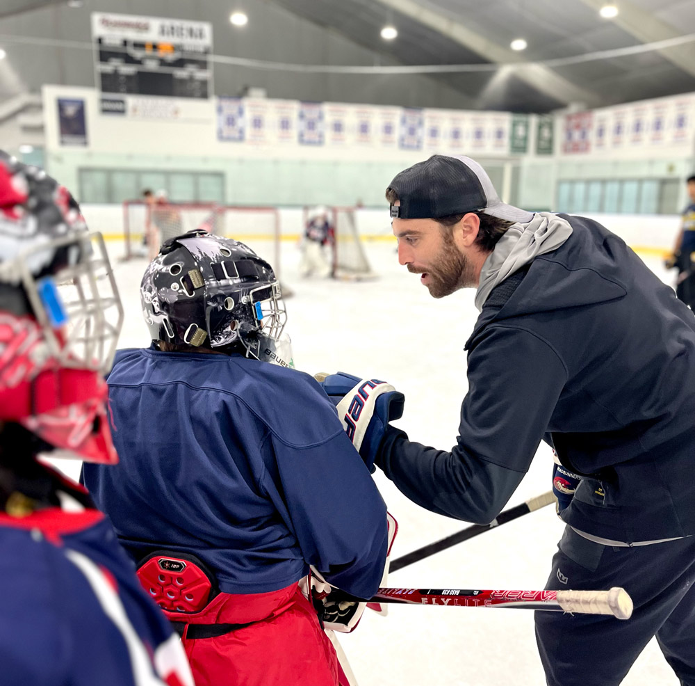Kyle Lane, Keserich Goaltending coach, giving one-on-one instruction to a young goalie on the ice