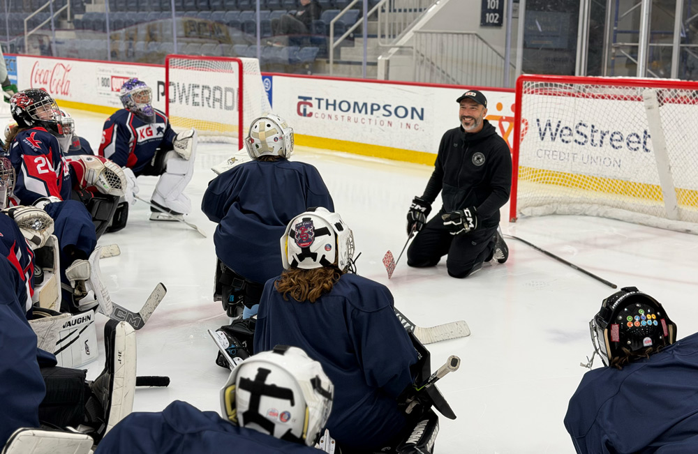 Coach and goalies by the net